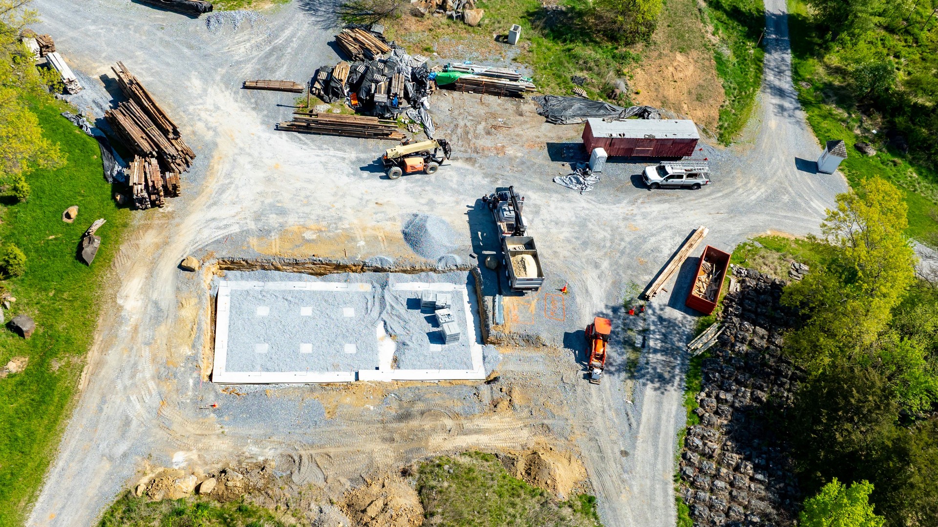 Construction Site Progress With Foundation Laid and Materials Organized in Rural Area
