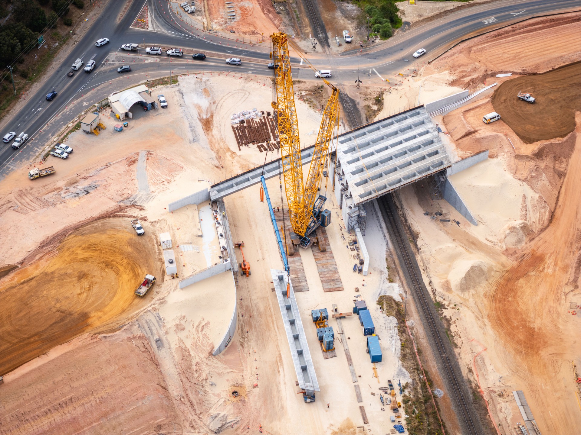 Aerial View of Bridge Construction Site with Heavy Machinery and Vehicles